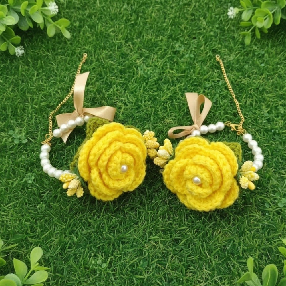 Pair of yellow floral earrings with gold accents on a green grass background